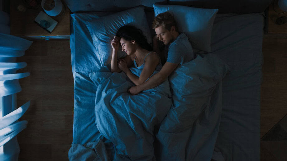 couple in bed at night time in the dark