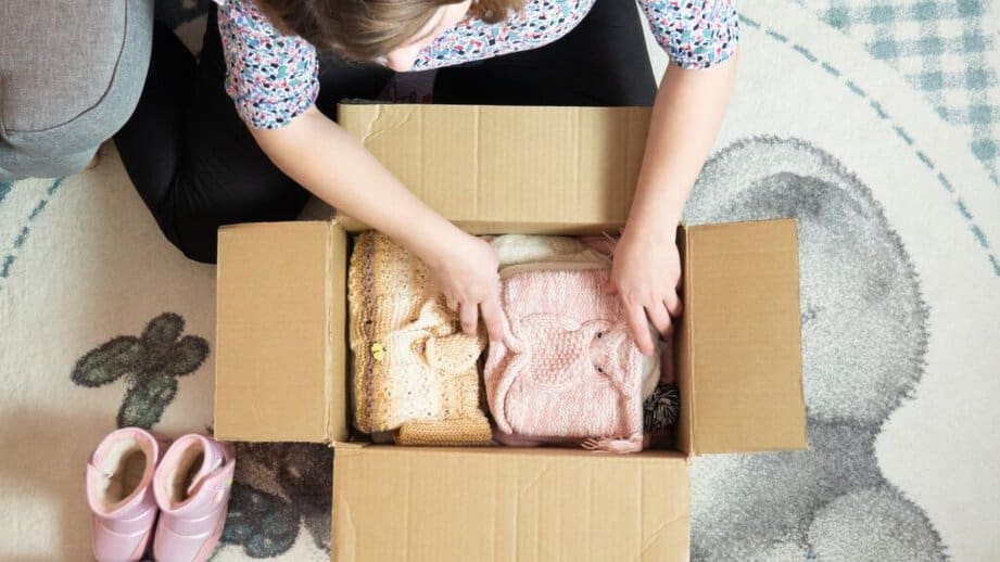 woman packing up baby clothes