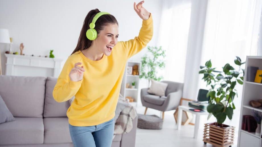 woman dancing with headphones on