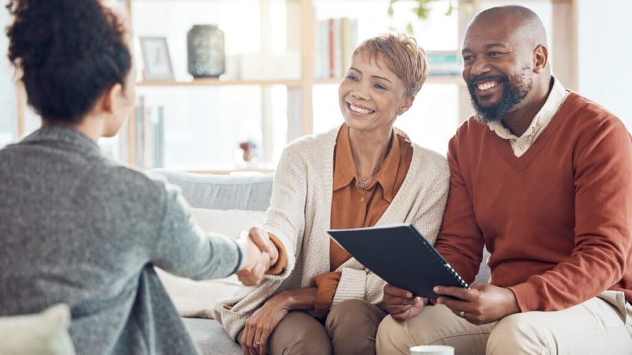 Older couple shaking hands with accountant