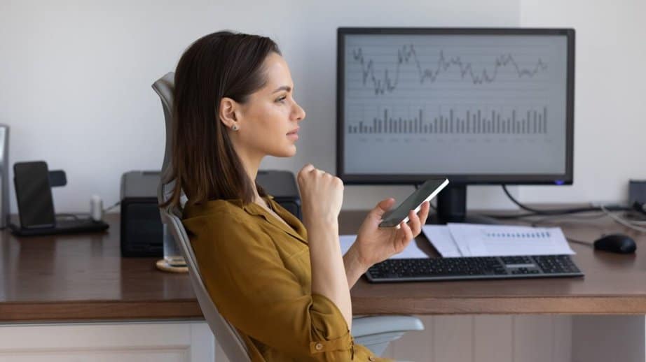 woman looking at phone while at work