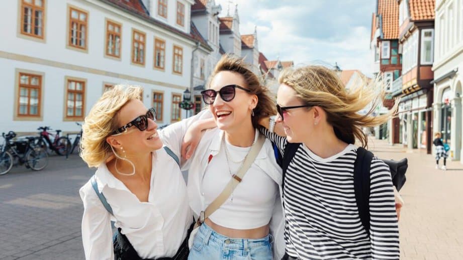 three friends on vacation laughing