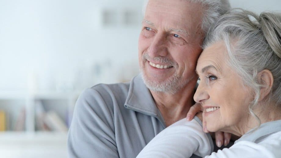 happy older couple looking in the distancce