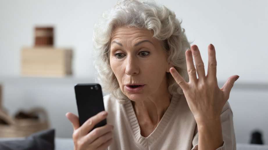 mature woman confused by smartphone