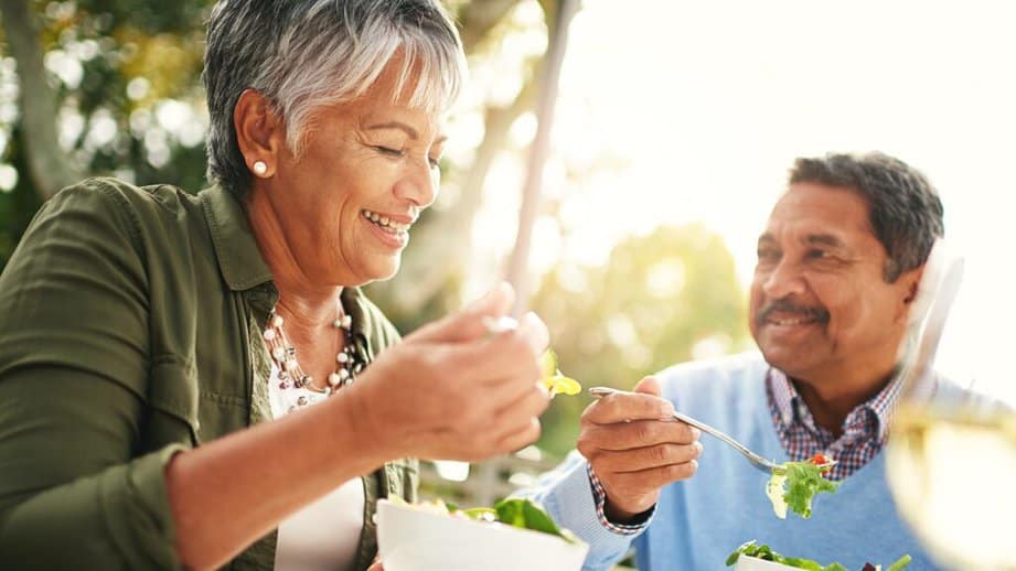 older couple eating salad