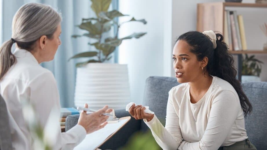 woman talking to a therapist on a couch