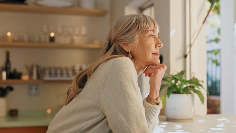 elderly woman looking out the window