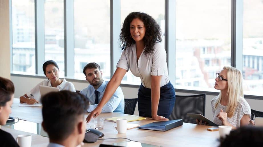 woman standing up in a meeting at work