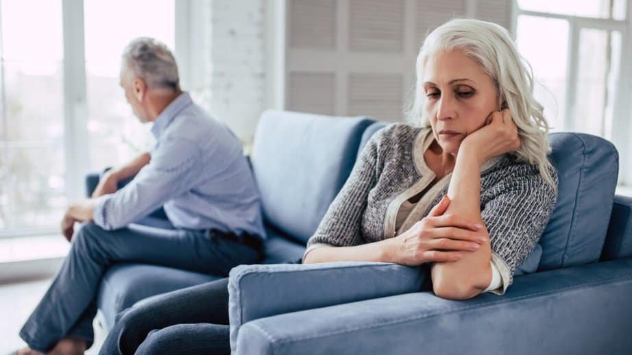 mature couple on the couch upset