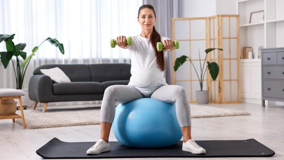 pregnant woman exercising on yoga ball