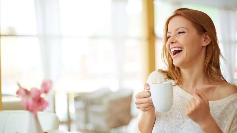 single happy woman drinking coffee