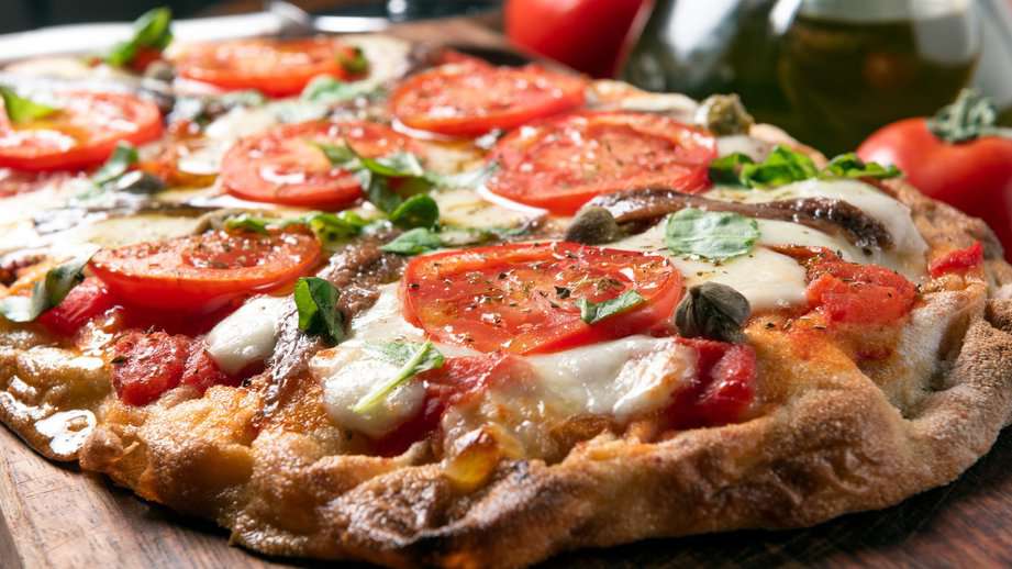 roman Pinsa with tomatoes and mozzarella cheese