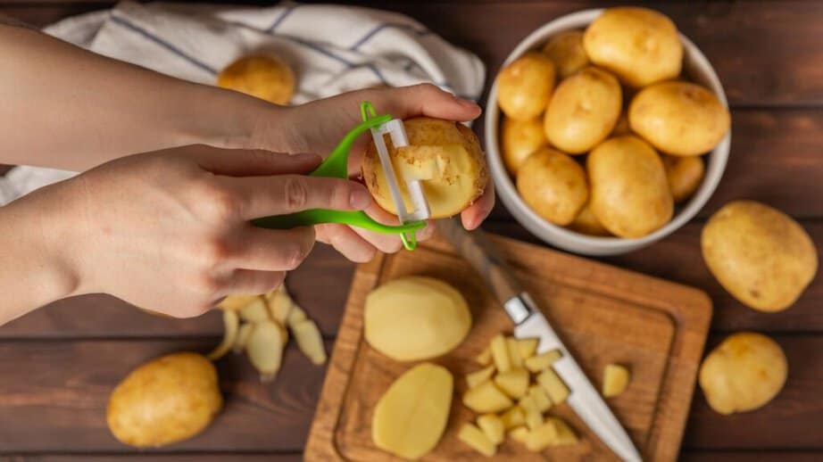 tray of potatoes being peeled