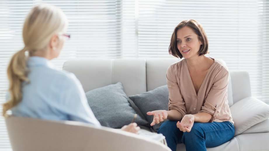 woman talking to therapist on the couch